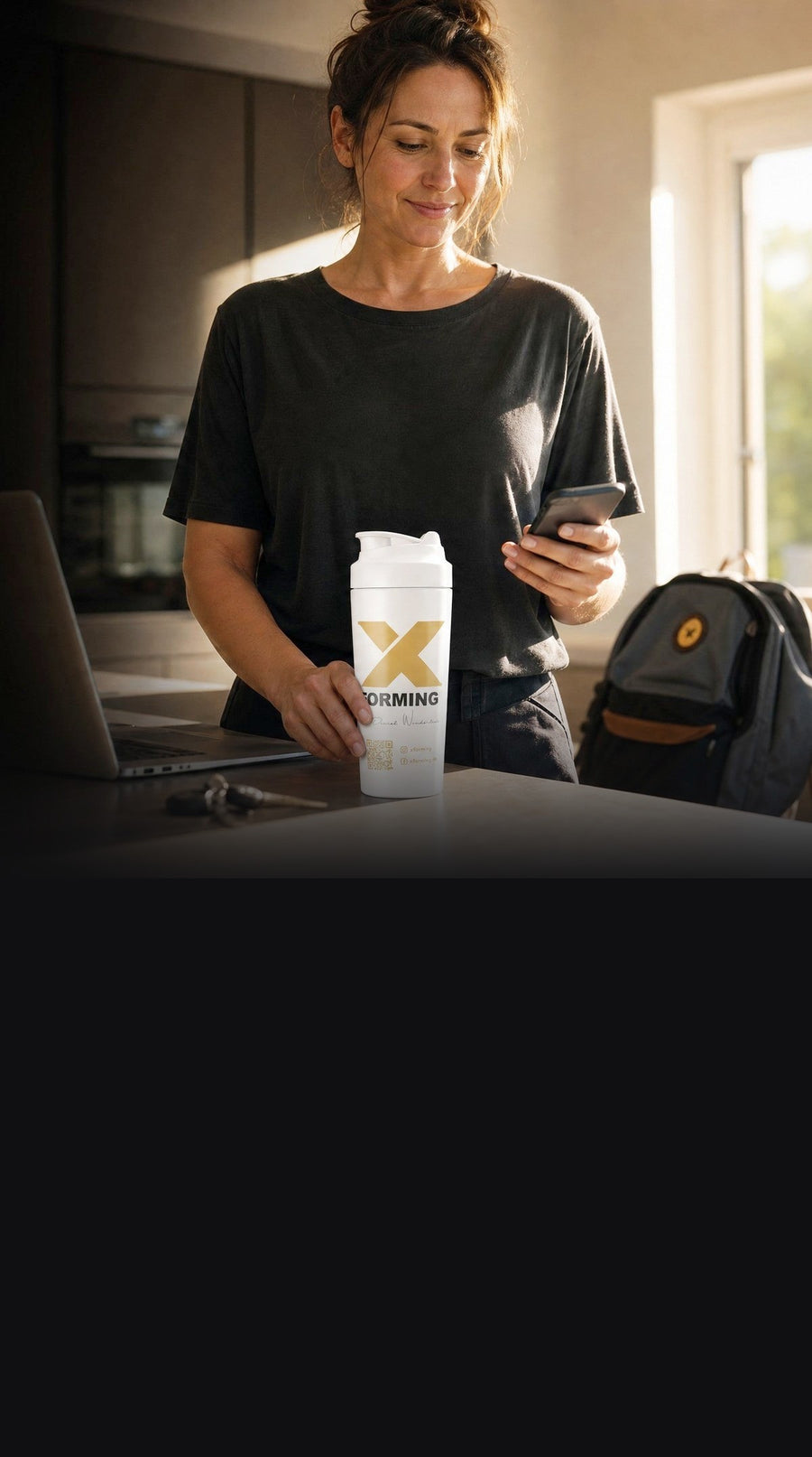 Frau mit X-FORMING Shaker in der Küche, morgens vor dem Arbeitstag